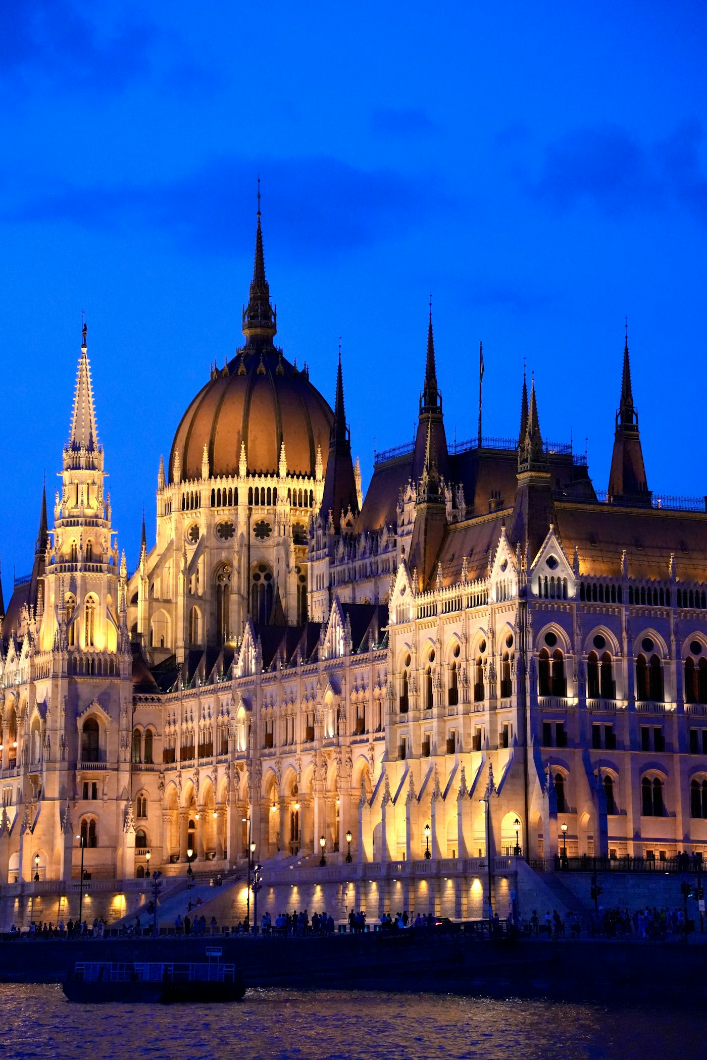 The Hungarian Parliament Building in Budapest lit up at night beside the Danube